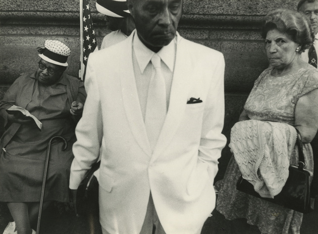 Untitled (man in white suit, women on either side), date unknown 
